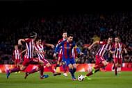 BARCELONA, SPAIN - FEBRUARY 07: Lionel Messi (C) of FC Barcelona runs with the ball between Filipe Luis (L), Nicolas Gaitan (2nd L) and Diego Godin (R) of Atletico de Madrid during the Copa del Rey semi-final second leg match between FC Barcelona and Atletico de Madrid at Camp Nou on February 7, 2017 in Barcelona, Spain. (Photo by Alex Caparros/Getty Images)